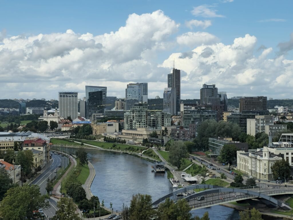pexels-photo-34246394-34246394 Stunning day view of Vilnius city skyline with the Neris River and modern architecture.